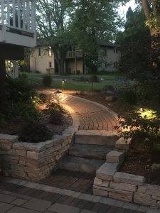 Evening view of a lit garden pathway and steps.